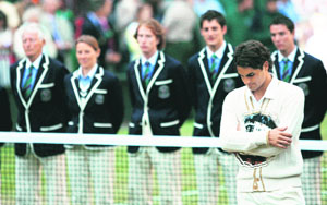 Roger Federer of Switzerland holds the runner-up trophy after losing to Rafael Nadal of Spain in their finals match at the Wimbledon tennis championships in London on Sunday.
