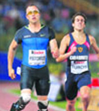 Double amputee Oscar Pistorius (L) of South Africa crosses the finish line of the men's 400 meters during the Golden Gala IAAF Golden League at the Olympic stadium in Rome