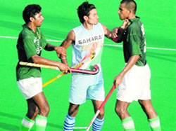 Fierce encounter: India's captain Gurbaj Singh (centre) clashes with Pakistani players during the semifinals of the Junior Asia Cup in Hyderabad