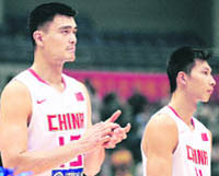 China's NBA players Yao Ming (L) and Yi Jianlian applaud following the national anthems ahead of their game against Serbia in the Stankovic Cup in Hangzhou on July 17 where China defeated Serbia 96-72.