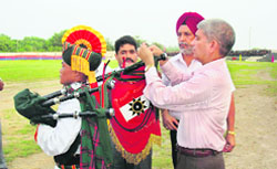 Lt-Gen Vinay Sharma, GOC of Rising Star Corps, ties the winner banner to the instrument of a winning team member at Mamun, near Pathankot, 