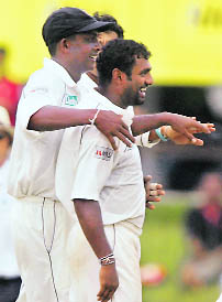 Sri Lanka�s Ajantha Mendis (L) and Muttiah Muralitharan celebrate their victory over India at their first Test match in Colombo on Saturday.