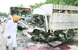 Wreckage of a PRTC bus and a canter that collided head-on near Bhucho