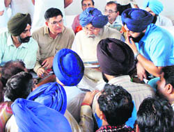 Chief Minister Parkash Singh Badal listens to problems of people at a Sangat Darshan in Amritsar on Friday. 
