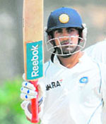 Gautam Gambhir raises his bat to the crowd after scoring a half-century on Saturday. 