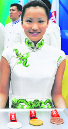 A hostess presents Olympic medals for the winners of the equestrian events in Hong Kong on Saturday. Hong Kong is host to the equestrian events. 
