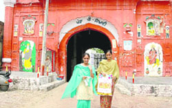 Two girls in front of the gate dedicated to the girl child in Otalana village, near Samrala