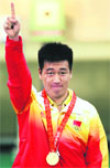 Pang Wei of China gestures after winning the gold medal in the men's air pistol shooting competition at the Beijing 2008 Olympic Games Saturday. � Reuters