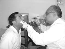 Dr Sanjay Sachdeva examines a patient at a camp in Kangra.
