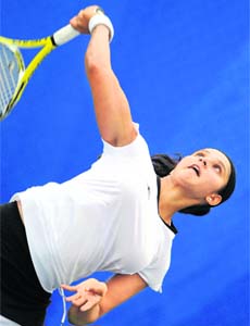 Sania Mirza serves to Iveta Benesova of the Czech Republic during their first round match in Beijing