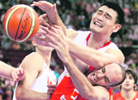 Yao Ming of China (top) and Carlos Jimenez of Spain battle for a rebound during a Group B men�s basketball game