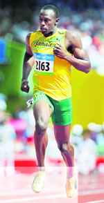 Usain Bolt of Jamaica competes in the men�s 100m heat at the National Stadium on Friday. 