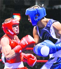 Akhil Kumar (R) fights against Moldova's Veaceslav Gojan during their bantamweight quarterfinal bout on Monday in Beijing