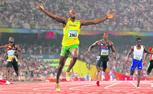 Jamaican sprint star Usain Bolt (C) raises his arms in victory in the final of the men's 200m at the Bird's Nest during the 2008 Beijing Olympic Games on Wednesday. Bolt won gold and broke the world record.