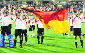 Germany�s players celebrate their gold medal victory over Spain in hockey final at the Olympic Green Hockey Stadium on Saturday.