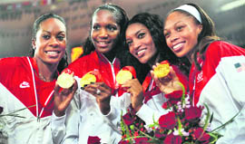 US athletes Sanya Richards, Mary Wineberg, Monique Henderson and Allyson Felix pose with their gold medals after winning the women's 4x400m relay at the National stadium as part of the 2008 Beijing Olympic Games on Saturday.