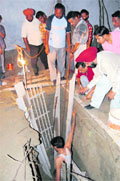 Fire Brigade officials try to save a labourer from a pit in Amritsar