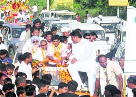 Boxers Vijender Kumar and Akhil Kumar accompanied by Ajay Chautala being carried in a procession through the streets of Bhiwani