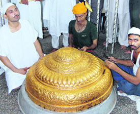 Artisans make a golden canopy with 12 kg of gold for Guru Granth Sahib’s palanquin to be presented to Takht Hazoor Sahib to mark the 300th Gurta Gaddi Divas in Amritsar on Wednesday.