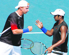 Lukas Dlouhy (L) of the Czech Republic and Leander Paes in action during the men�s doubles semifinal match against the Argentine pair of Maximo Gonzales and Juan Monaco at the US Open on Wednesday.