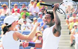 Cara Black, left, of Zimbabwe, and Leander Paes, of India, celebrate their win after the mixed doubles final match at the U.S. Open tennis tournament 