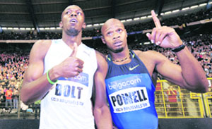 Jamaica's winner Usain Bolt (L) and compatriot Asafa Powell celebrate after the men's 100m competition at the Athletics Golden League meeting, Memorial Van Damme, in Brussels on Friday.