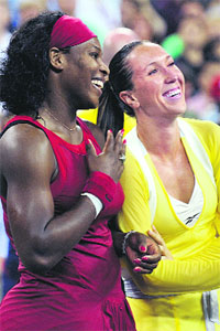 Serena Williams of the USA and Jelena Jankovic of Serbia laugh as they receive their trophies after the women's final at the US Open tennis tournament on Sunday in New York. Serena won 6-4, 7-5.