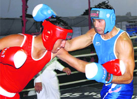 Mahendra Singh of Rajasthan (Red) and Narendra of Delhi fight on the third day of 55th Senior National boxing championship, at Bathinda on Monday.
