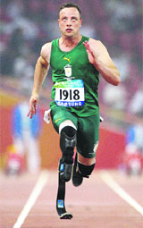 South Africa's Oscar Pistorius runs during his heat of the Men's 100m T44 at the Bird's Nest, during the Paralympics in Beijing on Monday.