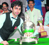 Pankaj Advani poses with the trophy of the world title for the time format at the IBSF World Billiards Championships in Bangalore 