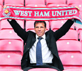 Former Chelsea and Italy footballer Gianfranco Zola poses for photographs at the West Ham football ground in east London