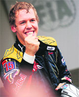 Toro Rosso�s German driver Sebastien Vettel celebrates in the parc ferme of the Monza racetrack after the qualifying session of the Italian Formula One Grand Prix on Saturday.