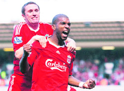 Liverpool�s Dutch forward Ryan Babel (R) is congratulated by Robbie Keane after he scored the winning goal.