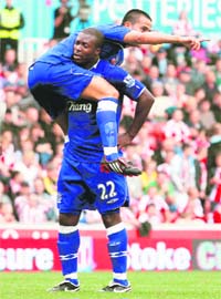 Everton�s Ayegbeni Yakubu (R) celebrates his goal against Stoke City with teammate Tim Cahill in central England