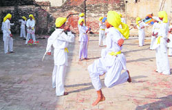 Children practise gatka at border village of Narli in Tarn Taran district on Saturday. 