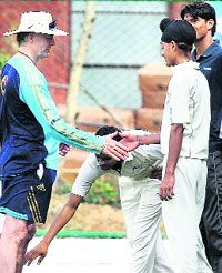 Young Indian cricketers greet former Indian coach during the Australian cricket team training session in Jaipur 