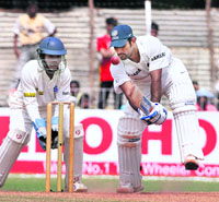 Rest of India batsman M S Dhoni plays a shot during the second innings of the Irani Trophy match against Delhi at Reliance Stadium in Vadodara 