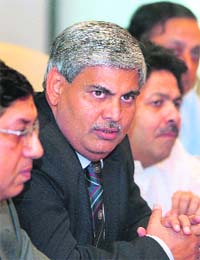 Shashank Manohar (C), the new president of the BCCI speaks as officials Rajiv Shukla (R) and N. Srinivasan (L) during a news conference in Mumbai