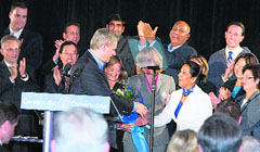 Prime Minister Stephen Harper greets party candidate Nina Grewal at an election meeting in Surrey, BC. Other candidates can also be seen in the picture.