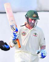 Australia's Mike Hussey raises his bat after completing his half century against Board President�s XI on the second day of the four-day warm-up match in Hyderabad