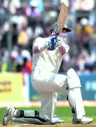 Mike Hussey plays a shot on the 2nd day of the first Test match against India at Chinnaswamy stadium.