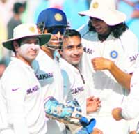 Amit Mishra (C) celebrates with teammates after taking the wicket of Peter Siddle during the third day of the second Test between India and Australia at Mohali. 