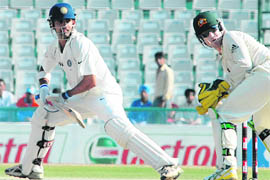 Gambhir plays a shot as Brad Haddin looks on during the fourth day of the second Test between India and Australia in Mohali on Monday.