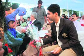 Abhinav Bindra receiving a bouquet from a student at a felicitation function at Riverdale School where he studied as a child in Dehradun. 