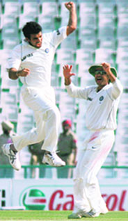 Zaheer Khan and Virender Sehwag (right) celebrate the dismissal of Cameron White.