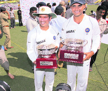 Sachin Tendulkar and Sourav Ganguly (R) hold their special trophies during the presentation ceremony after India won the second Test against Australia in Mohali on Tuesday.