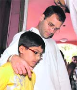 Aman Rehman, who is son of a motor mechanic, with Rahul Gandhi in Dehradun on Wednesday. 