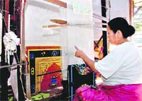 WEAVING MAGIC: A women weaves a carpet at the Tibetan Women Centre at Rajpur.
