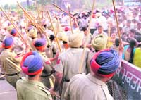 Policemen lathicharge agitating computer teachers at Kheowali village, Muktsar district, on Sunday. 