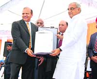 Haryana CM Bhupinder Singh Hooda confers roll of honour on Prof Rajinder M. Gupta at the Founders Day function of Punjab Public School in Nabha on Sunday. 